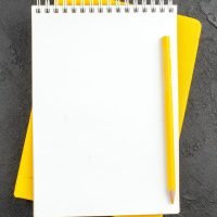 top-view-spiral-notepad-yellow-pencil-black_140725-144662